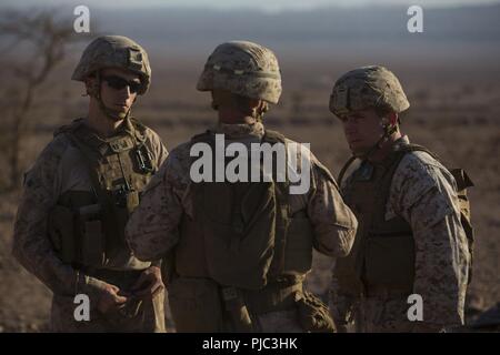 CAMP TITIN, Jordan (July 8, 2018) U.S. Marine Corps Col. Farrell J. Sullivan (right), commanding officer, 26th Marine Expeditionary Unit (MEU), speaks with unit leaders about demolitions during sustainment training at Camp Titin, Jordan, July 8, 2018. Iwo Jima is the flagship for the Iwo Jima Amphibious Ready Group and, with the embarked 26th Marine Expeditionary Unit, is deployed to the U.S. 5th Fleet area of operations in support of naval operations to ensure maritime stability and security in the Central region, connecting the Mediterranean and the Pacific through the western Indian Ocean a Stock Photo