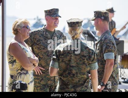 Maj. Gen. Mark R. Wise, the outgoing commanding general of 3rd Marine Aircraft Wing, and his wife Terry speak with Maj. Bjorn Thoreen, executive officer of Marine Heavy Helicopter Squadron (HMH) 462, and his wife following the change of command ceremony at Marine Corps Air Station Miramar, Calif., July 13. Wise took command of 3rd MAW July 22, 2016. Under his command, 3rd MAW trained, equipped and deployed Marines with four Marine Expiditionary Units and with Special Purpose Marine Air-Ground Task Force - Crisis Response - Central Command. 3rd MAW also continued its modernization with the stan Stock Photo