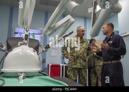 PACIFIC OCEAN (July 12, 2018) Vice Adm. Forrest Faison (left), Navy Surgeon General and chief of the U.S. Navy Bureau of Medicine and Surgery (BUMED), speaks with Lt. Cmdr. Kyle Gadbois, director of surgical services aboard Military Sealift Command hospital ship USNS Mercy (T-AH 19), while aboard for a ship tour and admiral’s call during the Rim of the Pacific (RIMPAC) exercise, July 12. Twenty-five nations, more than 45 ships and submarines, about 200 aircraft, and 25,000 personnel are participating in RIMPAC from June 27 to Aug. 2 in and around the Hawaiian Islands and southern California. T Stock Photo