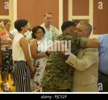 Capt. Jamie J. Grifaldo’s Family congratulate him during his retirement ceremony July 13, on Marine Corps Base, Camp Lejeune, North Carolina. Since 1994, Grifaldo has devoted his life to making a better Marine Corps. This ceremony marks the day he retires after 24 years of service. Stock Photo