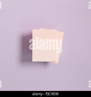 Pink memo pad, sticky notes on purple background Stock Photo