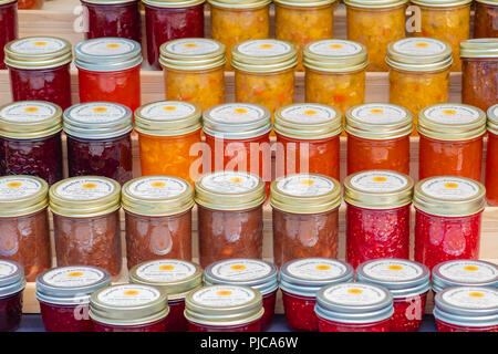 Fresh made jams and jellies on display and for sale at a local farmers market. Stock Photo