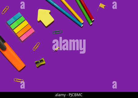 set of various school supplies on a purple surface Stock Photo