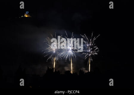 Three fireworks on the feast of the patron saint of the city whose church is visible in the background, Vittorio Veneto, Italy Stock Photo