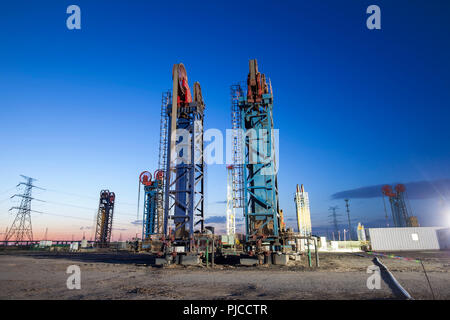 Oil field, the tower type pumping unit in the evening Stock Photo