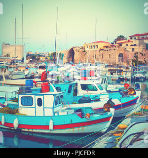 Old fishing boats in the port of Heraklion in the evening,  Crete, Greece. Vintage styled image Stock Photo