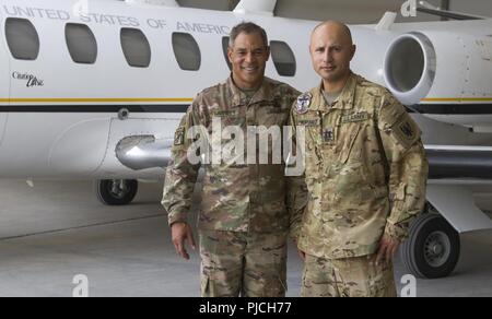 U.S. Army Lt. Gen. Michael X. Garrett, U.S. Army Central (USARCENT) commanding general, poses for a photo with U.S. Army Capt. Arturo Montanez with the UC-35 Jet Detachment, Alpha Company, 6-52nd Aviation Battalion at Ali Al Salem Air Base, Kuwait, July 21, 2018. Lt. Gen. Garrett visited the Air Base to thank members of the flight team for supporting USARCENT's mission of maintaining an enduring presence in forward areas. Stock Photo