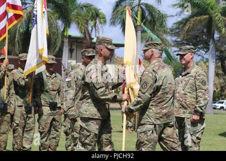 FORT SHAFTER FLATS, Hawaii -The official passing of the colors from 9th Mission Support Command Commanding General Brig. Gen. Douglas Anderson, center right, to incoming U.S. Army Reserve Theater Sustainment Group - Pacific commander Col. Travis Delk, center left, ceremonially signifies the tradition of passing responsibility for the unit. Stock Photo