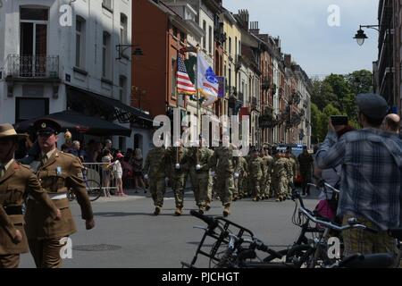Soldiers from the 12th Combat Aviation Brigade and the 21st Theater Sustainment Command march in the Belgian National Day Parade in Brussels, Belgium on 21 July, 2018, commemorating the 100th Anniversary of the end of World War I.  Units from United States European Command are participating in numerous ceremonies throughout Europe to honor those that made the ultimate sacrifice over a century ago. Stock Photo