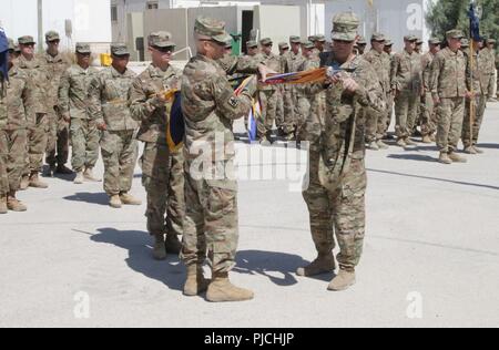 AMMAN, JORDAN – Lt. Col. Phillip Armstrong (left) and Command Sgt. Maj. Travis Armstrong case the 1st Battalion, 184th Infantry Regiment’s flag as they transfer the authority to the incoming unit and prepare to return home from a year-long deployment overseas. Stock Photo