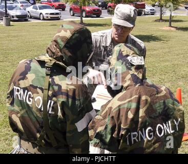 Senior Master Sgt. Richard Bailey (center), installation emergency manager, 117th Civil Engineering Squadron, instructs 117 ARW Airmen in Ability to Survive and Operate training at Sumpter Smith Air National Guard Base, Birmingham, Ala., July 22, 2018.  The training gives Airmen the skillset to defend themselves against chemical, biological, nuclear and radiological attacks and operate in environments with agents present. Stock Photo