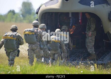 U.S. Army Paratroopers assigned to 173rd Airborne Brigade, along with British, French, Spanish and Italian Paratroopers, board a 12th Combat Aviation Brigade CH-47 Chinook helicopter for an airborne operation at Juliet Drop Zone in Pordenone, Aviano, Italy, July 19, 2018. The combined exercise demonstrates the multinational capacity building of the airborne community and focused on enhancing NATO operational standards and developing individual technical skills Stock Photo
