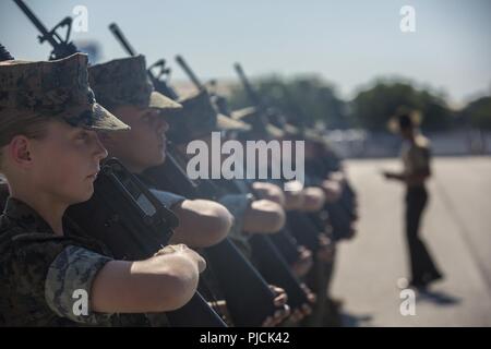 U.S. Marine Corps recruits with Platoon 4036, Oscar Company, 4th Recruit Training Battalion, execute a drill movement during Initial Drill at Peatross Parade Deck on Marine Corps Recruit Depot Parris Island, S.C., July 23, 2018. The recruits are scored for initial drill according to confidence, attention to detail, and discipline. Stock Photo