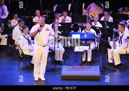 N.D. (July 23, 2018) - Chief Musician Tommy Horner, a native of Pittsburgh and a member of Navy Band Great Lakes, sings during a concert at the Fargo Theatre during Fargo-Moorhead Metro Navy Week. The Navy Office of Community Outreach uses the Navy Week program to bring Navy Sailors, equipment and displays to approximately 14 American cities each year for a week-long schedule of outreach engagements designed for Americans to experience first hand how the U.S. Navy is the Navy the nation needs. Stock Photo