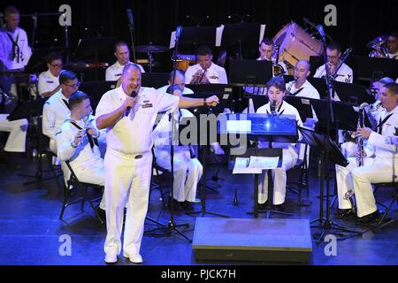 N.D. (July 23, 2018) - Chief Musician Tommy Horner, a native of Pittsburgh and a member of Navy Band Great Lakes, sings during a concert at the Fargo Theatre during Fargo-Moorhead Metro Navy Week. The Navy Office of Community Outreach uses the Navy Week program to bring Navy Sailors, equipment and displays to approximately 14 American cities each year for a week-long schedule of outreach engagements designed for Americans to experience first hand how the U.S. Navy is the Navy the nation needs. Stock Photo