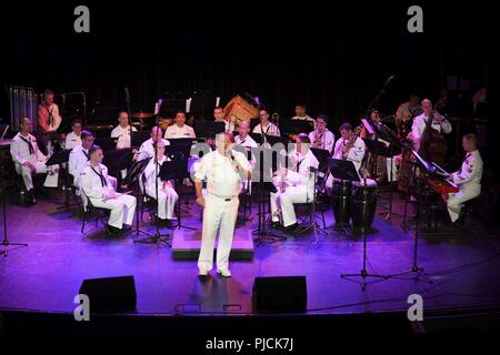 N.D. (July 23, 2018) - Chief Musician Tommy Horner, a native of Pittsburgh and a member of Navy Band Great Lakes, sings during a concert at the Fargo Theatre during Fargo-Moorhead Metro Navy Week. The Navy Office of Community Outreach uses the Navy Week program to bring Navy Sailors, equipment and displays to approximately 14 American cities each year for a week-long schedule of outreach engagements designed for Americans to experience first hand how the U.S. Navy is the Navy the nation needs. Stock Photo