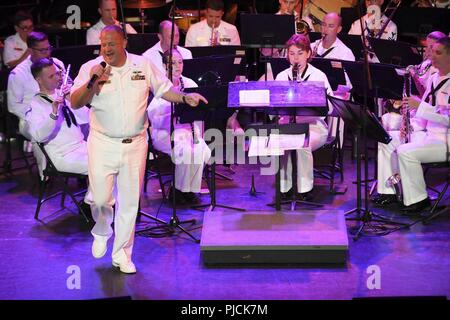 N.D. (July 23, 2018) - Chief Musician Tommy Horner, a native of Pittsburgh and a member of Navy Band Great Lakes, sings during a concert at the Fargo Theatre during Fargo-Moorhead Metro Navy Week. The Navy Office of Community Outreach uses the Navy Week program to bring Navy Sailors, equipment and displays to approximately 14 American cities each year for a week-long schedule of outreach engagements designed for Americans to experience first hand how the U.S. Navy is the Navy the nation needs. Stock Photo