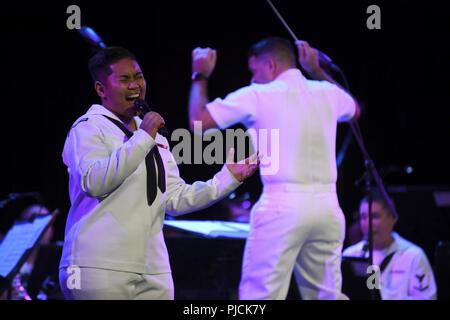 N.D. (July 23, 2018) - Musician 3rd Class Danlie Cuenca, a native of Norfolk, Va. and a member of Navy Band Great Lakes, sings during a concert at the Fargo Theatre during Fargo-Moorhead Metro Navy Week. The Navy Office of Community Outreach uses the Navy Week program to bring Navy Sailors, equipment and displays to approximately 14 American cities each year for a week-long schedule of outreach engagements designed for Americans to experience first hand how the U.S. Navy is the Navy the nation needs. Stock Photo