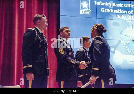 U.S. Army 1st Lt. Leslie R. Greenfield of the California Army National Guard, right, is congratulated after completing the Infantry Basic Officer Leadership Course (IBOLC) July 20 at Fort Benning, Georgia, becoming Cal Guard’s first female infantry officer. Stock Photo