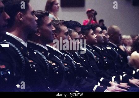 U.S. Army 1st Lt. Leslie R. Greenfield, center, sits with graduation comrades July 20 after completing the Infantry Basic Officer Leadership Course (IBOLC), becoming the California Army National Guard’s first female infantry officer. Greenfield received her certification at Fort Benning, Georgia. Stock Photo