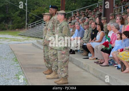 FORT BENNING, Ga. (July 24, 2018) – From background to foreground, Col. Michael A. Scarpulla, incoming commander of the Airborne and Ranger Training Battalion, Maj. Gen. Gary M. Brito, commanding general of the Maneuver Center of Excellence and Fort Benning, and Col. Douglas G. Vincent, outgoing commander of the ARTB, stand together during the ARTB change of command ceremony. The ARTB held a change of command July 24 at Victory Pond at Fort Benning, Georgia, welcoming Scarpulla to command and bidding farewell to Vincent. Stock Photo