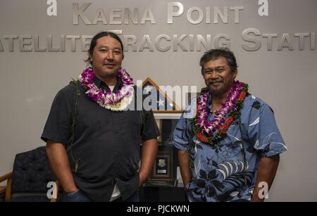 Jason Fukumoto, Detachment 3, 21st Space Operations Squadron electrician, and Robin Albios, Det. 3, 21st SOPS heating, ventilation and air conditioning specialist, pose for a photo after receiving the Air Force Civilian Award for Valor at the Kaena Point Satellite Tracking Station, Hawaii, July 23, 2018. Two years ago, Fukumoto and Albios provided medical aid to a state of Hawaii volunteer field crew member who suffered from smoke inhalation during a fire at the Kuaokala Game Management Area. Stock Photo