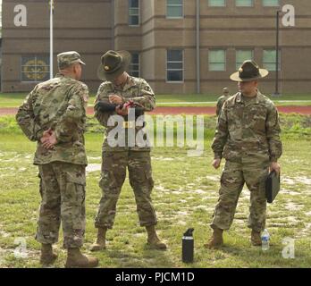 Charlie Company Drill Sergeant Leaders grade drill sergeant candidates on their knowledge of modules at the U.S. Army Drill Sergeant PT field,  July 24. Candidates must be able to pitch and demonstrate modules. Soldiers serving at the Drill Sergeant School are hand-picked from a select group of noncommissioned officers and are charged with preparing the Army’s elite for becoming a drill sergeant. Stock Photo