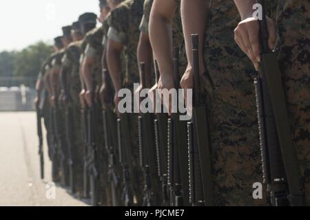 U.S. Marine Corps recruits with Platoon 4036, Oscar Company, 4th Recruit Training Battalion, execute a drill movement during Initial Drill at Peatross Parade Deck on Marine Corps Recruit Depot Parris Island, S.C., July 23, 2018. The recruits are scored for initial drill according to confidence, attention to detail, and discipline. Stock Photo