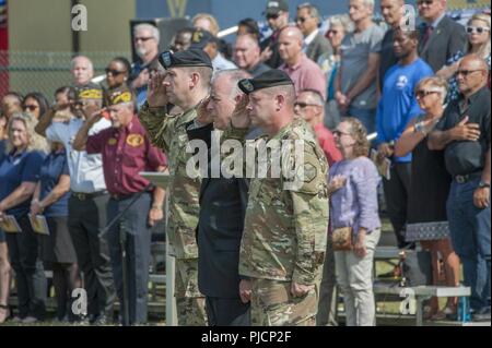 Ansbach, Germany -- United States Army Garrison (USAG) Ansbach outgoing Commander Col. Benjamin C. Jones passes the unit colors to Mr. Michael D. Formica, Installation Management Command Europe Region director during the USAG Ansbach Change of Command ceremony at Barton Barracks parade field, Ansbach, Germany, July 18, 2018. Stock Photo