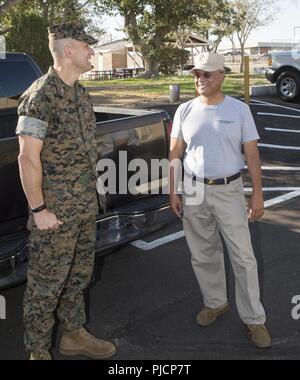 Colonel Craig Clemans, MCLB Barstow commanding officer, and Jose Perez, excutive officer of the Excelsior Charter School Young Marines program, have a chuckle while discussing the Young Marines' training regiment for the week, aboard MCLB Barstow, July 24. Stock Photo