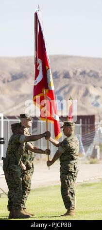 Colonel Sekou Karega, commanding officer, relinquishes the colors during the change of command ceremony held on Sorensen Field aboard Marine Corps Logistics Base Barstow, Calif., July 19. As Col. Karega heads to his new command in South Korea, Col. Craig Clemans assumes command of MCLB Barstow. Stock Photo