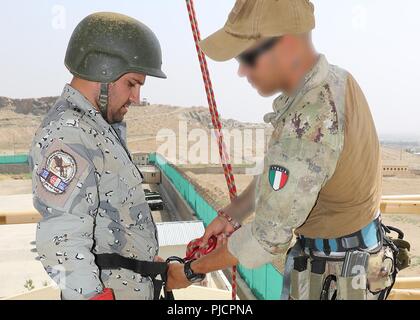 KABUL, Afghanistan (July 18, 2018) -- A Resolute Support advisor from Italy assists a police recruit with his fast-roping harness during police training at the Special Police Training Center, near Kabul, Afghanistan, July 18, 2018. 350 Afghan police recruits, trained by a Croatian Special Operations Advisory Team (SOAT) and coalition forces are participating in a six-month long course. (NATO Stock Photo