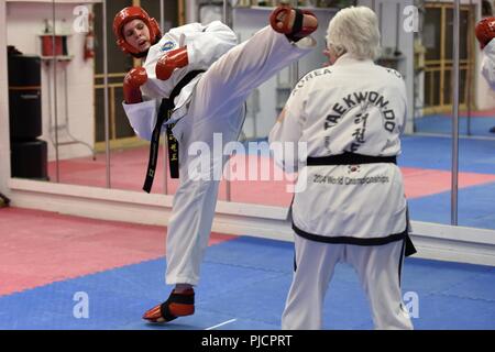 1st Class Lydia Delmonico, an information technology specialist assigned to the 180th Fighter Wing, Ohio Air National Guard, trains for the International Taekwondo Federation World Championships by sparring against her instructor at Great Lakes Global Taekwondo in Sylvania, Ohio, July 11,2018. The ITF World Championships take place from July 31through Aug. 5 in Buenos Aires, Argentina. Stock Photo