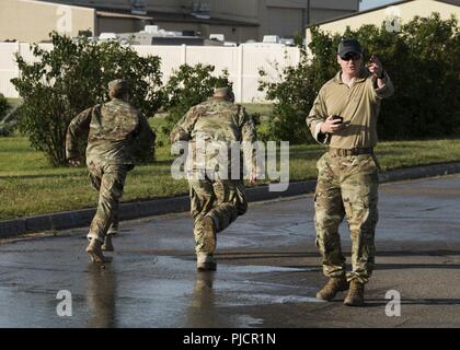 Master Sgt. Derrick Smith, 91st Security Forces Group Tactical Response Force superintendent, supervises Airmen during the TRF tryouts at Minot Air Force Base, North Dakota, July 18, 2018. TRF is a special weapons and tactics team tasked with protecting Minot Air Force Base’s nuclear assets. Stock Photo