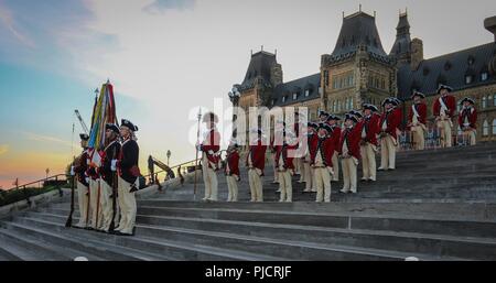 Soldiers with the Fife and Drum Corps and U.S. Army Continental Color Guard, 3d U.S. Infantry Regiment (The Old Guard), pose during a performance at the Fortissimo Tattoo 2018 in Ottawa, Canada, July 20, 2018. Fortissimo is a three night military spectacular which has drawn thousands of spectators since it began in 1997. The event also featured performances from Canadian’s Massed Pipes and Drums and the Ceremonial Guard. Stock Photo