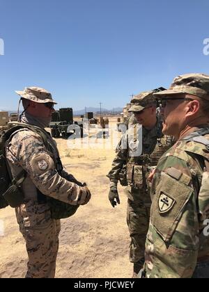 Chaplain (1st Lt.) Marko Tiirmaa (left), an operations staff officer of the Estonian Defense Forces, engages with with Ch. (Lt. Col.) Daniel W. Son (right), officer in charge of the 114th Chaplain Detachment and other Soldiers during a training exercise at Fort Hunter Liggett, Calif., July 9-20. Stock Photo