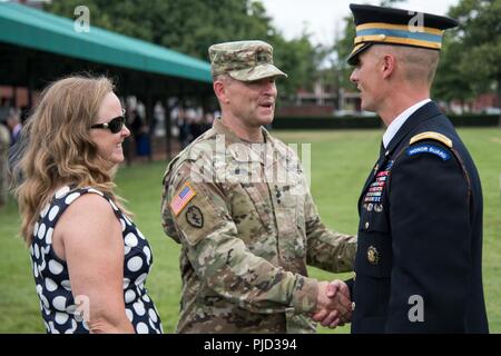 Maj. Gen, Bradley A. Becker (center), shakes hands with Col. Jason T. Garkey, outgoing commander, 3d U.S. Infantry Regiment, (The Old Guard), following a change of command, change of responsibility ceremony, on Summerall Field, July 17, 2018. During the ceremony, Garkey relinquished command to Col. James J. Tuite, while Command Sgt. Maj. Scott Beeson, the outgoing regimental command sergeant major, transferred responsibility to Command Sgt. Maj. Edwin T. Brooks. Stock Photo