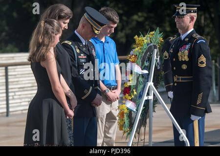 Col. Jason T. Garkey (center), outgoing commander, 3d U.S. Infantry Regiment, (The Old Guard), and his family participate in an Army Special Honor Wreath-laying Ceremony at the Tomb of the Unknown Soldier, Arlington National Cemetery, Arlington, Va., July 17, 2018. As Garkey departs The Old Guard, a wreath is laid to commemorate his more than two years of service as the regiment’s commander. Stock Photo