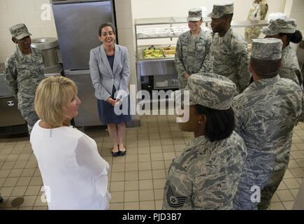 Deputy Assistant Secretary of Defense for Military Community and Family Policy, Mrs. Ann Thomas (A.T) Johnston, top middle, and Mississippi's First Lady, Deborah Bryant, lower left, visit with services airmen inside the kitchen they work in, who support the civil engineer airmen who are working on phase one construction of Camp Kamassa in Crystal Springs, Mississippi, July 17, 2018. Camp Kamassa will be the states first fully handicap accessible, year round camp facility for children and adults with special needs, that is being built on 326 acres spearheaded by the Air Force Reserve's Innovati Stock Photo