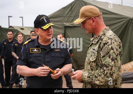 NAVAL BASE POINT LOMA, Calif. (July 17, 2018) Royal New Zealand Navy (RNZN) Commodore Tony Millar, maritime component commander and representative of the Chief of Navy (New Zealand), left, presents a gift to U.S. Navy Rear Adm. Dave Welch, commander, Task Force (CTF) 177, commander, Naval Surface and Mine Warfighting Development Center during a visit to Naval Base Point Loma. Millar visited CTF 177’s undersea mine countermeasures commander during the visit, coinciding with their participation in the Rim of the Pacific (RIMPAC) exercise 2018 in the Southern California area of operations, July 1 Stock Photo