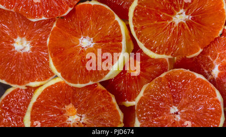 Background of fresh sliced sliced and peeled grapefruit fruits. Stock Photo