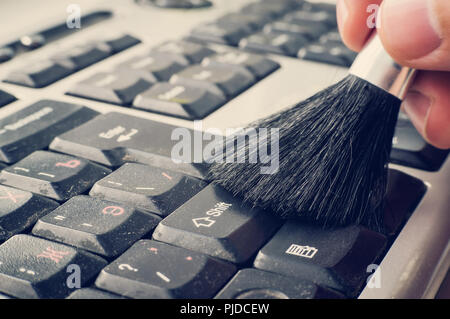 Computer literacy repair men hands, examines laptop clean Horizontal view of cleaning the keys on the keyboard Stock Photo