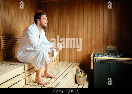Handsome man relaxing in sauna Stock Photo