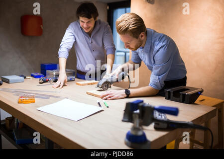 Two creative designers working in workshop Stock Photo