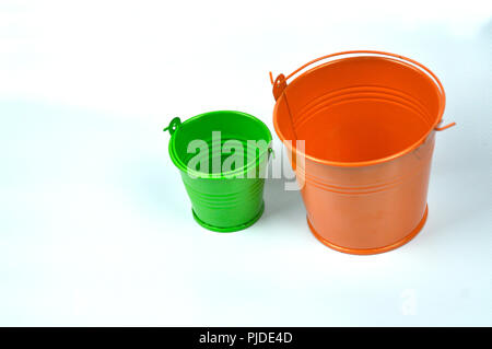 Small orange and green buckets isolated on white background. Stock Photo