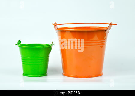 Small orange and green buckets isolated on white background. Stock Photo