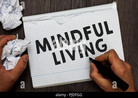 Writing note showing Mindful Living. Business photo showcasing Fully aware and engaged on something Conscious and Sensible Man holding marker notebook Stock Photo
