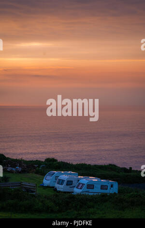 St. Ives, England -  May 2018 : Three large caravans on a camping site at dusk, Cornish coast, Cornwall, Stock Photo