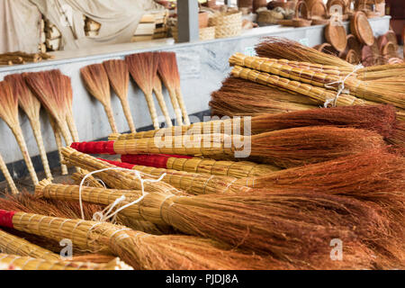 A pile of bamboo brooms in market for sale at Uzbekistan bazaar. Stock Photo