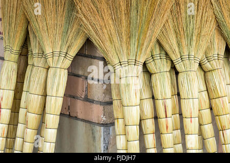 A pile of bamboo brooms in market for sale at Uzbekistan bazaar. Stock Photo